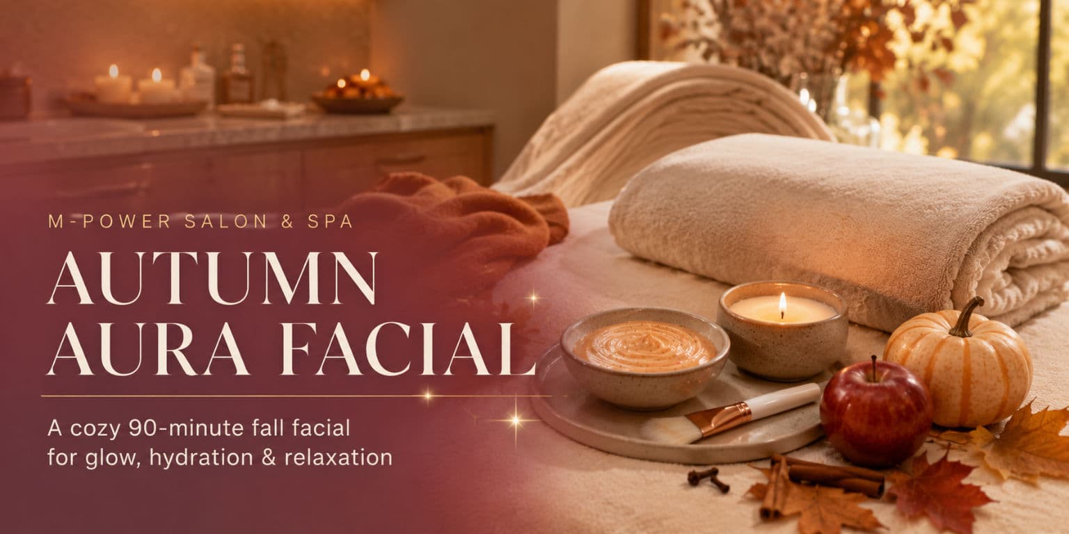 Folded spa towels, a skincare bowl, candle, apple, and pumpkin arranged on a treatment bed