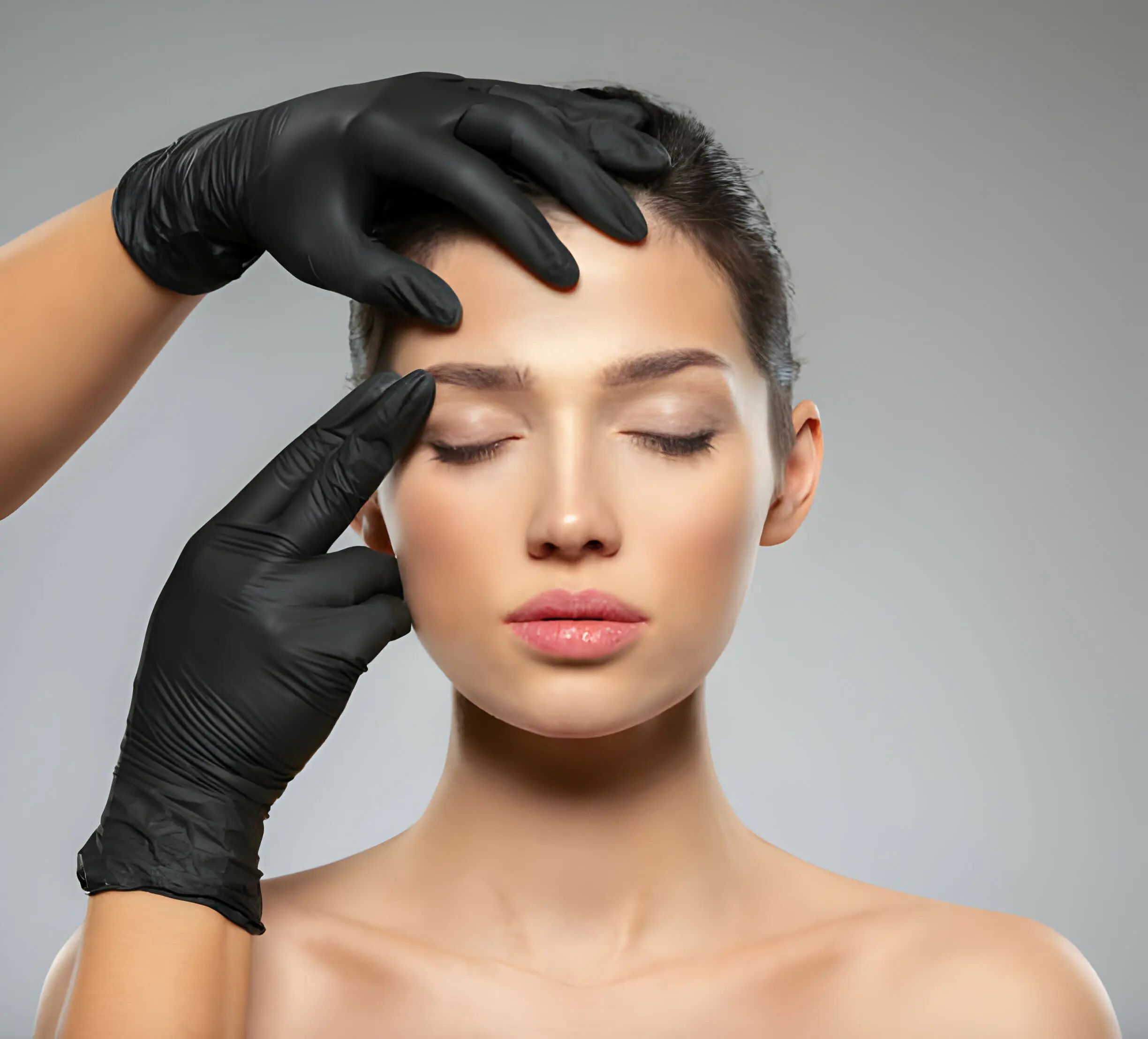Botox consultation — provider assessing forehead treatment areas Licensed aesthetics provider examining forehead treatment areas during a Botox consultation, assessing glabellar lines and forehead wrinkles before injection